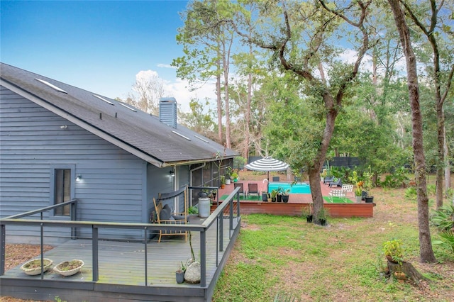 view of yard with a sunroom and a deck