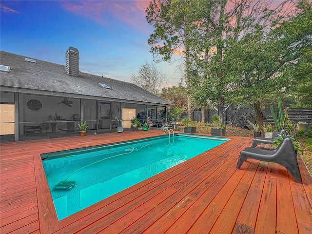 view of swimming pool featuring a fenced in pool, fence, and a wooden deck