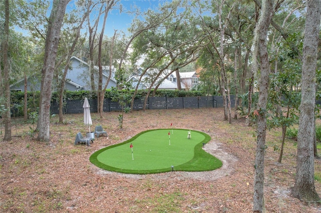 view of home's community featuring fence