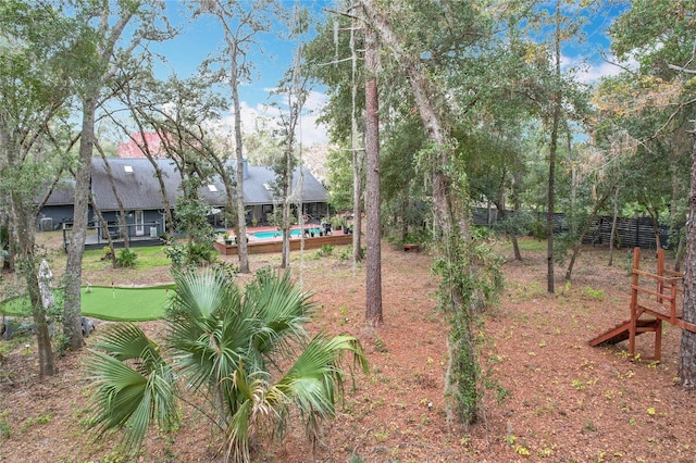 view of yard with a swimming pool and fence