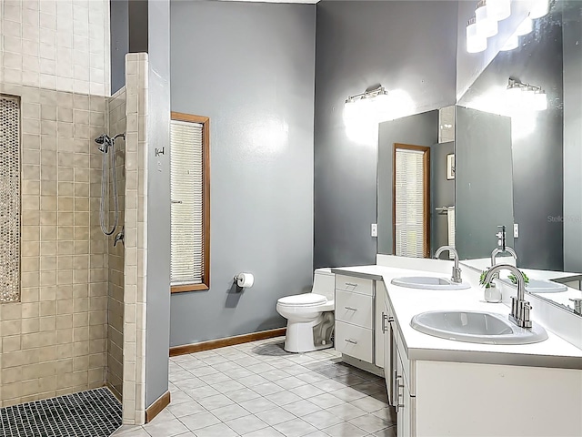 1701 Cedar Stone Ct, Lake Mary, FL 32746 - bathroom with tile patterned floors, double vanity, a tile shower, toilet, and baseboards