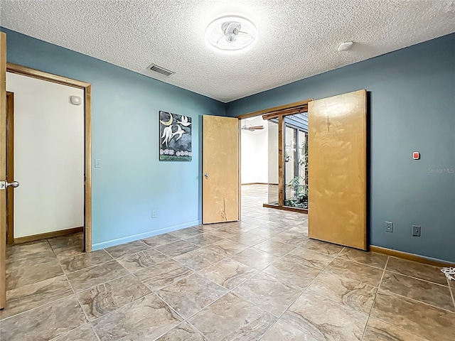 1701 Cedar Stone Ct, Lake Mary, FL 32746 - unfurnished room with a textured ceiling, baseboards, and a smoke detector