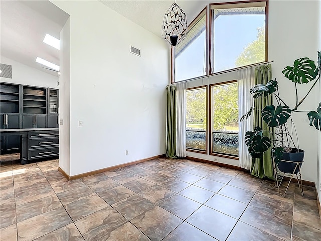 1701 Cedar Stone Ct, Lake Mary, FL 32746 - unfurnished dining area featuring high vaulted ceiling and baseboards