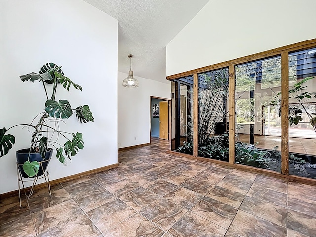 1701 Cedar Stone Ct, Lake Mary, FL 32746 - empty room with baseboards, high vaulted ceiling, and a textured ceiling