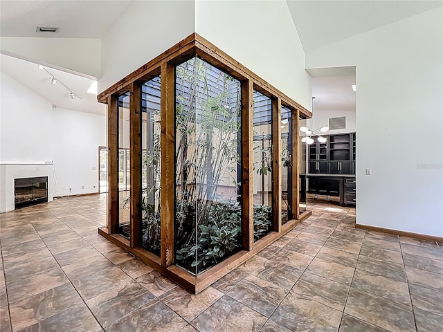 1701 Cedar Stone Ct, Lake Mary, FL 32746 - corridor featuring high vaulted ceiling, baseboards, and track lighting
