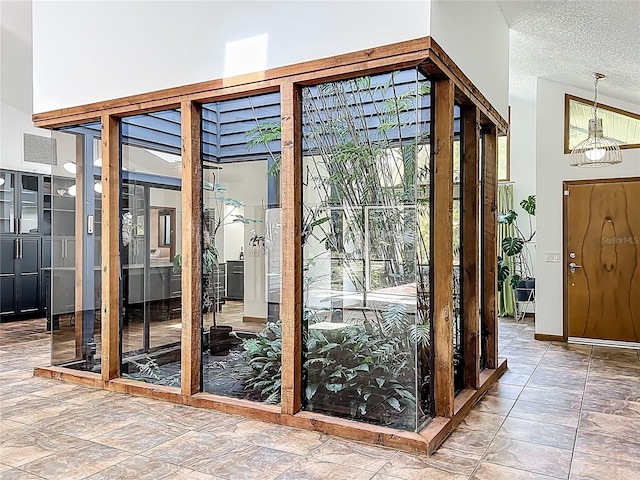 1701 Cedar Stone Ct, Lake Mary, FL 32746 - entryway featuring a textured ceiling and stone finish floors
