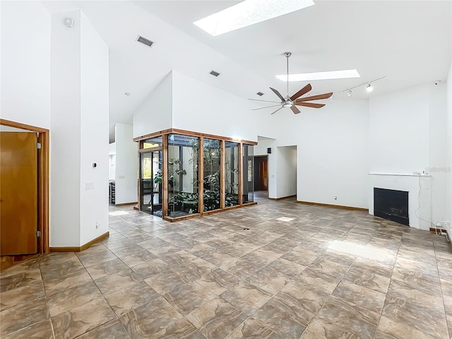 1701 Cedar Stone Ct, Lake Mary, FL 32746 - empty room featuring a skylight, high vaulted ceiling, ceiling fan, and baseboards