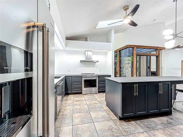 1701 Cedar Stone Ct, Lake Mary, FL 32746 - kitchen with stainless steel appliances, lofted ceiling, extractor fan, dark cabinets, and a skylight