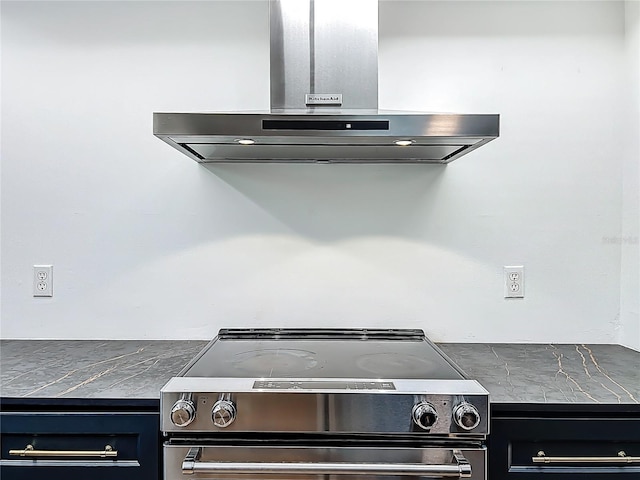 1701 Cedar Stone Ct, Lake Mary, FL 32746 - kitchen view of island range hood, stainless steel electric range, dark cabinetry, and dark countertops