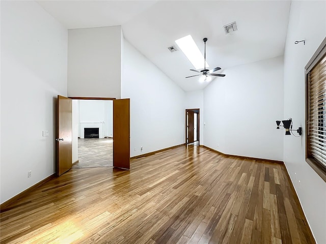 1701 Cedar Stone Ct, Lake Mary, FL 32746 - empty room featuring a fireplace, wood finished floors, high vaulted ceiling, and a ceiling fan