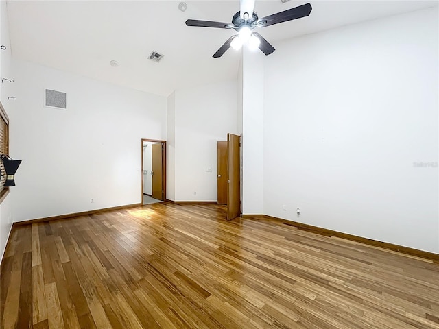 1701 Cedar Stone Ct, Lake Mary, FL 32746 - unfurnished living room with wood finished floors, a ceiling fan, high vaulted ceiling, and baseboards