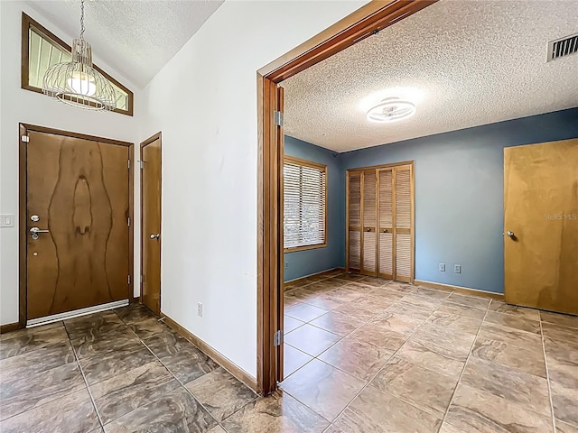 1701 Cedar Stone Ct, Lake Mary, FL 32746 - entrance foyer featuring a textured ceiling, baseboards, and vaulted ceiling