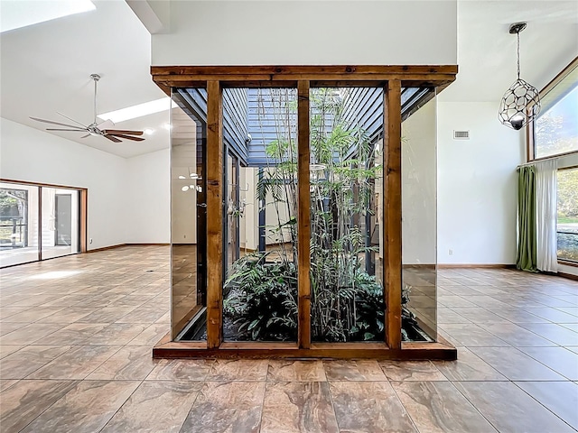 1701 Cedar Stone Ct, Lake Mary, FL 32746 - entryway featuring a towering ceiling, a ceiling fan, and baseboards