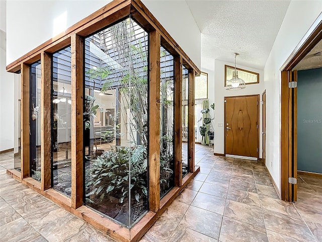 1701 Cedar Stone Ct, Lake Mary, FL 32746 - foyer entrance featuring baseboards, a textured ceiling, and a chandelier