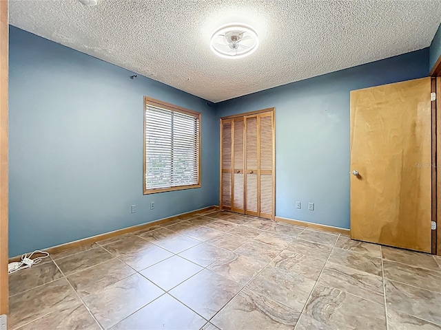 1701 Cedar Stone Ct, Lake Mary, FL 32746 - unfurnished bedroom featuring a textured ceiling, a closet, and baseboards