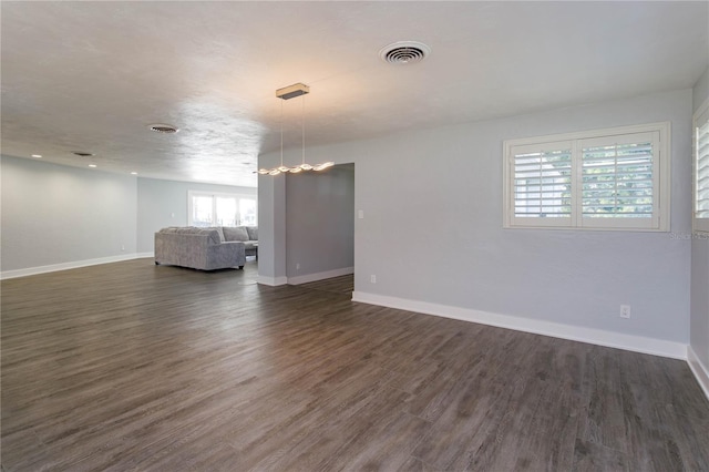 spare room with dark hardwood / wood-style floors