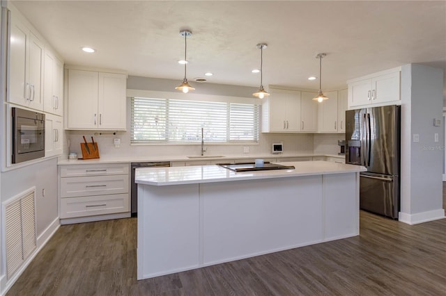 kitchen featuring a center island, sink, white cabinetry, and stainless steel appliances