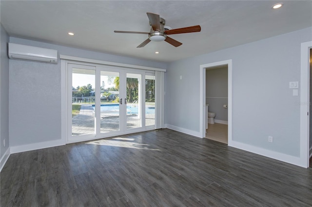 spare room featuring ceiling fan, an AC wall unit, dark wood-type flooring, and french doors