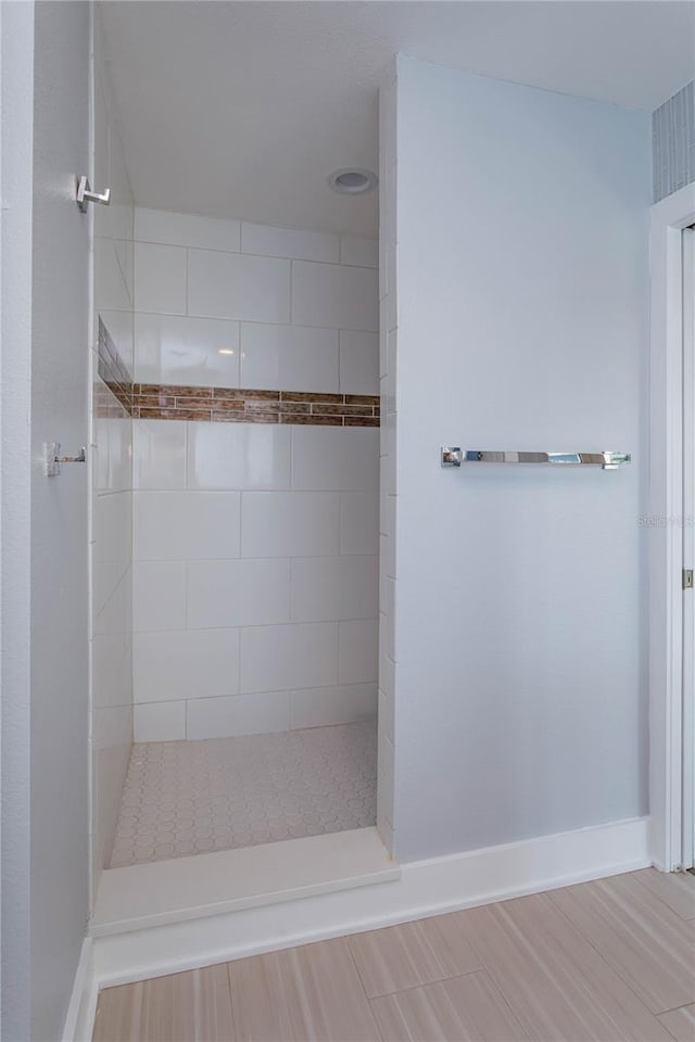 bathroom with tiled shower