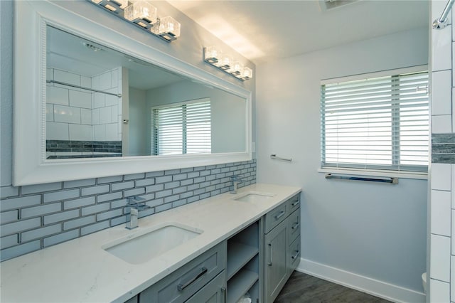 bathroom with decorative backsplash, wood-type flooring, vanity, and toilet