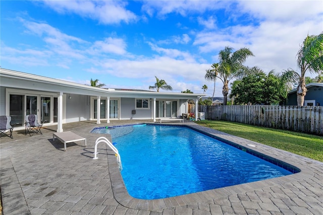 view of swimming pool with a yard and a patio