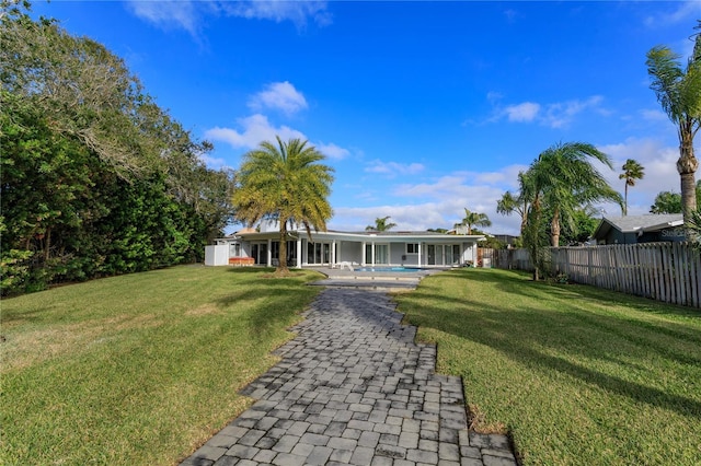 exterior space with a yard and a fenced in pool