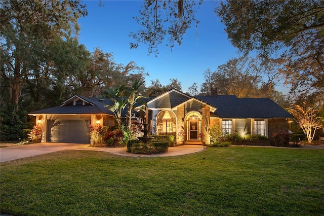 ranch-style house featuring a lawn and a garage