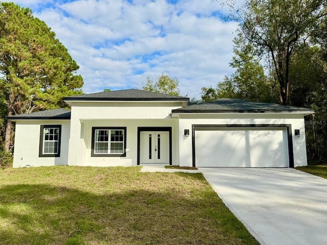 prairie-style house with a garage and a front lawn