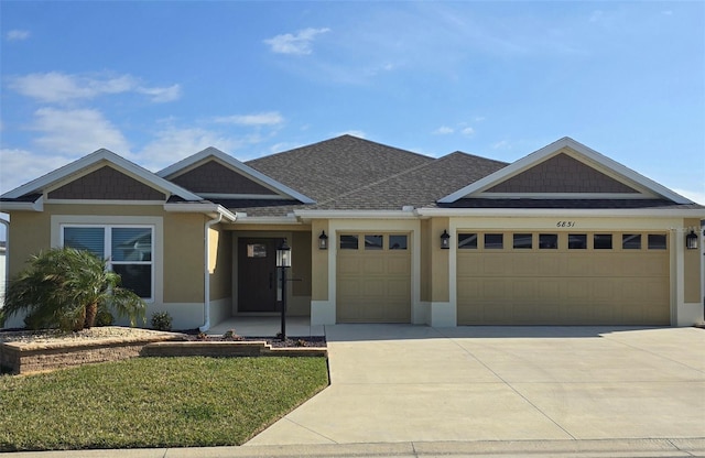 view of front of property with a front lawn and a garage