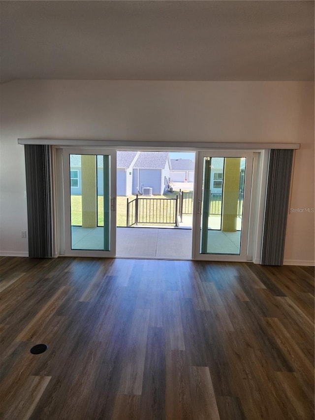 unfurnished room featuring dark hardwood / wood-style floors and plenty of natural light