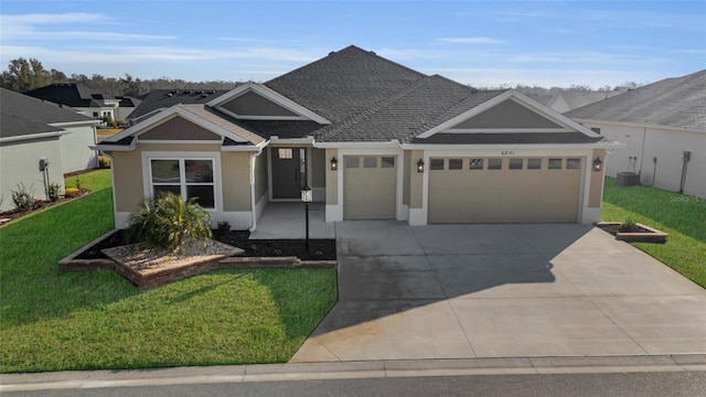 view of front of property featuring a garage and a front yard