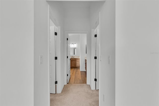 hallway with light colored carpet