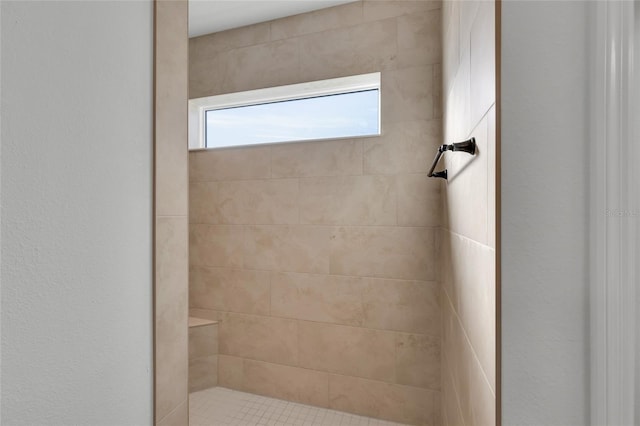 bathroom with tiled shower