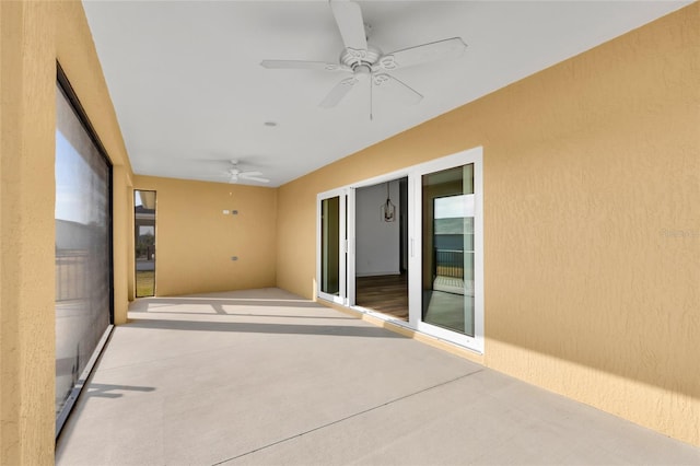 unfurnished sunroom featuring ceiling fan