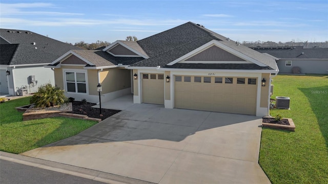 view of front of house with a garage, a front yard, and cooling unit