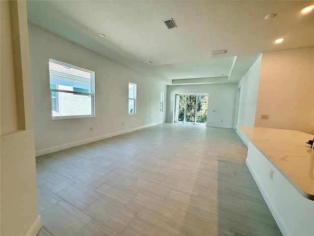 unfurnished living room with a textured ceiling