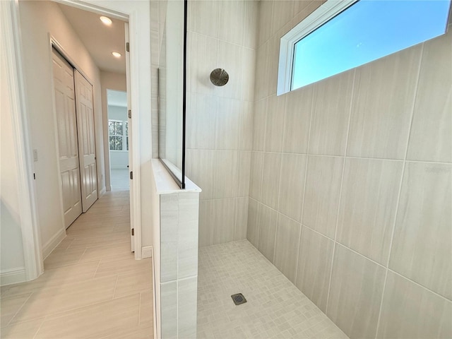 bathroom featuring tile patterned floors and tiled shower