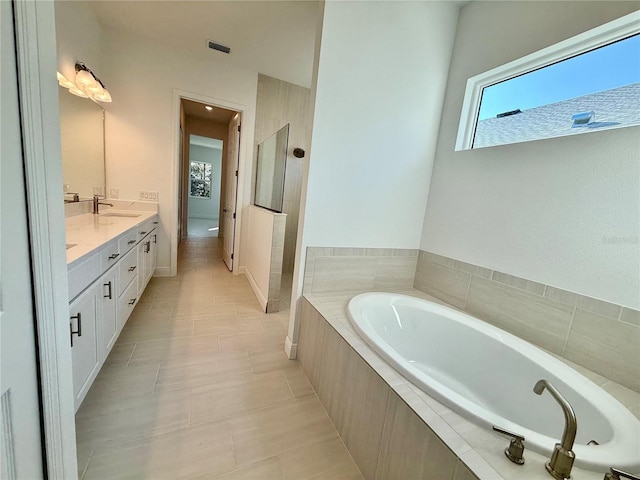 bathroom with tile patterned flooring, vanity, and shower with separate bathtub