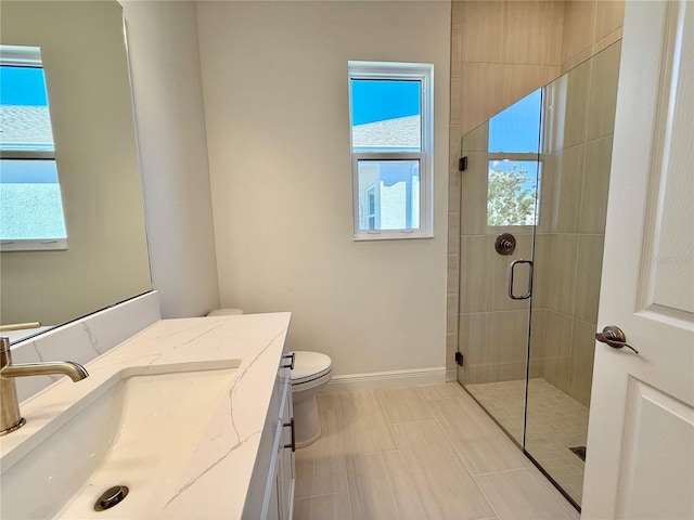 bathroom with vanity, toilet, and walk in shower