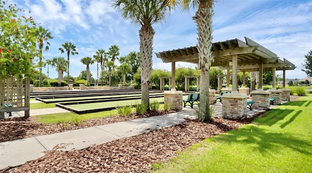 view of community with a yard and a pergola