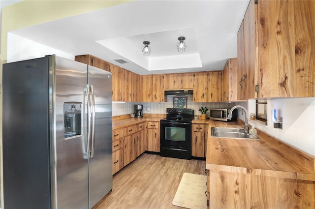 kitchen with exhaust hood, sink, tasteful backsplash, butcher block countertops, and stainless steel appliances