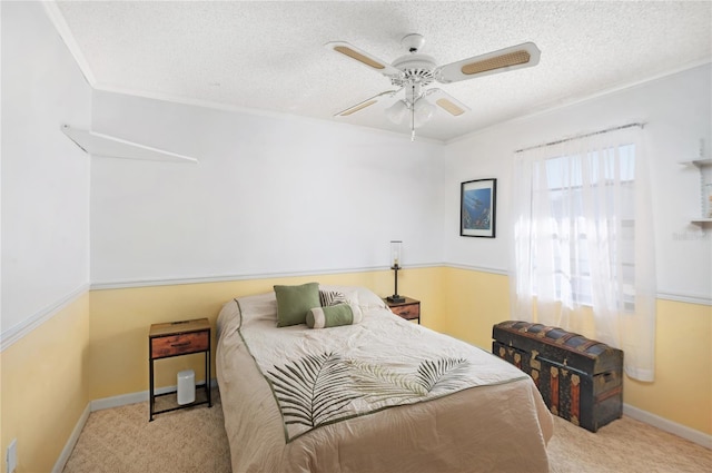 carpeted bedroom featuring a textured ceiling and ceiling fan