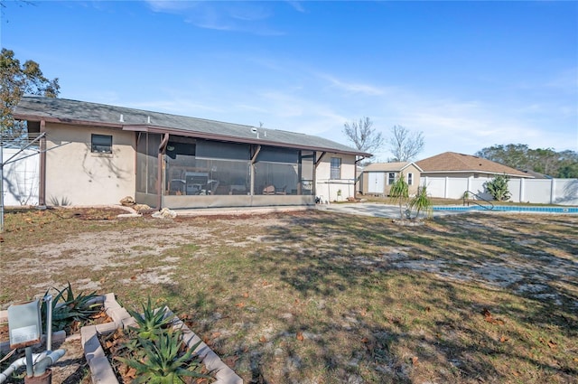 view of front of property with a front yard and a sunroom