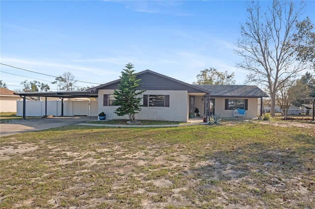 ranch-style home with a front yard and a carport