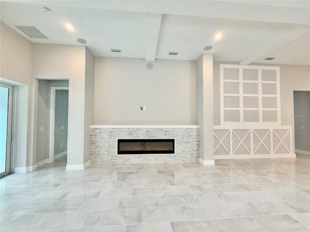 unfurnished living room featuring a fireplace and beamed ceiling