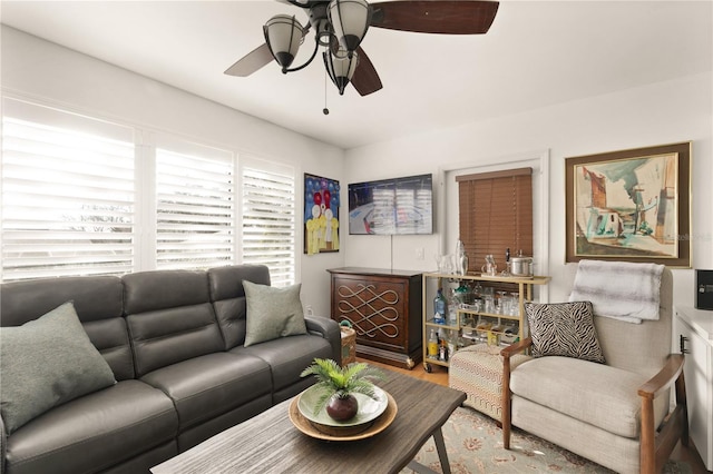 living area featuring wood finished floors and ceiling fan