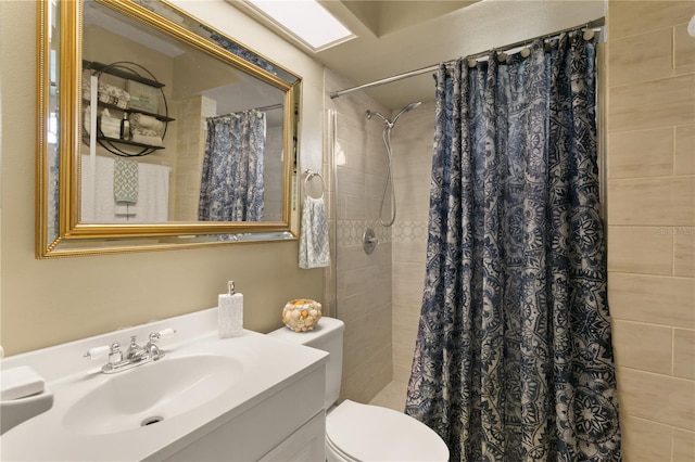 bathroom featuring vanity, curtained shower, and toilet