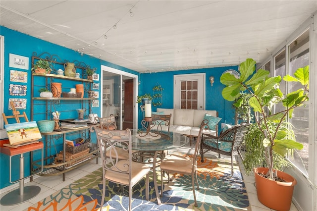 dining area featuring tile patterned floors and plenty of natural light