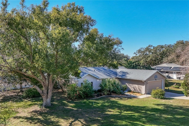 view of front of house with a front yard and a garage