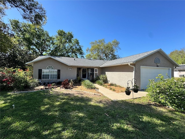 ranch-style home featuring a front yard, an attached garage, and brick siding